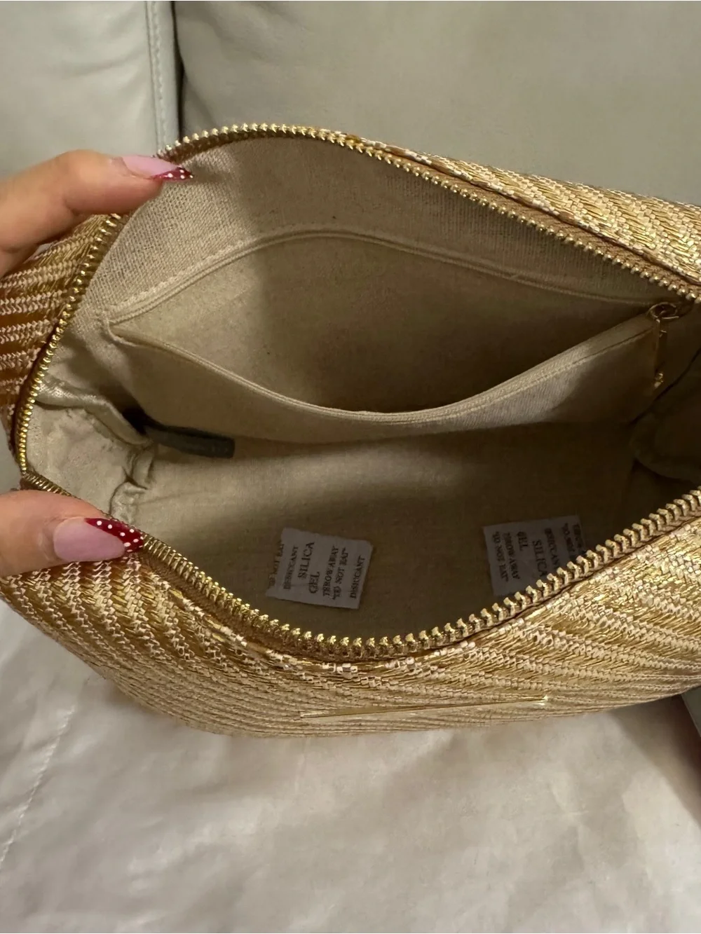 Vince Camuto gold woven canvas metallic cosmetic Bag with starfish Tassel charm.